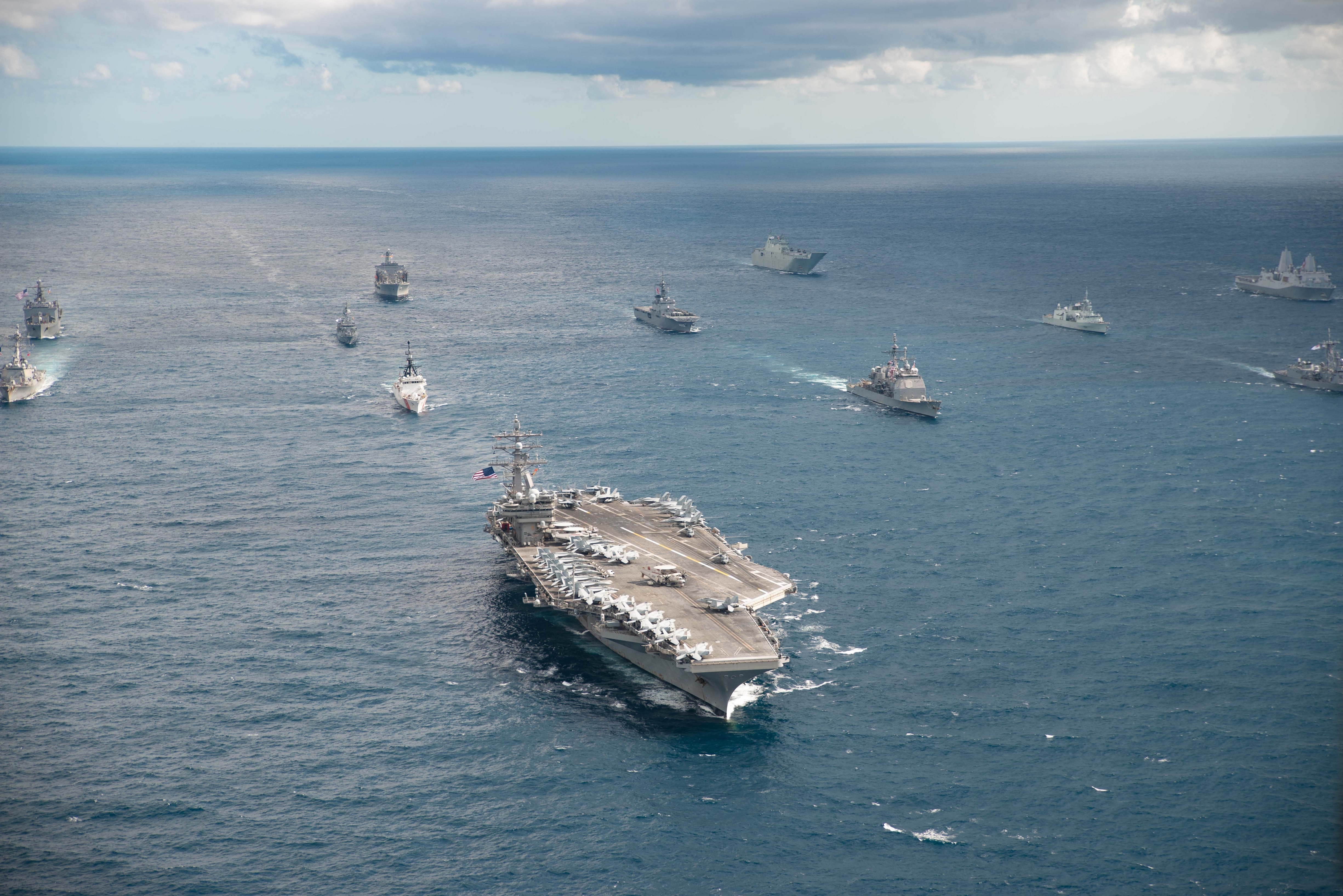 The U.S. Navy Nimitz-class aircraft carrier USS Ronald Reagan (CVN 76) leads a formation of 17 other ships during Talisman Sabre 2019 (Petty Officer 3rd Class Jason Ta)