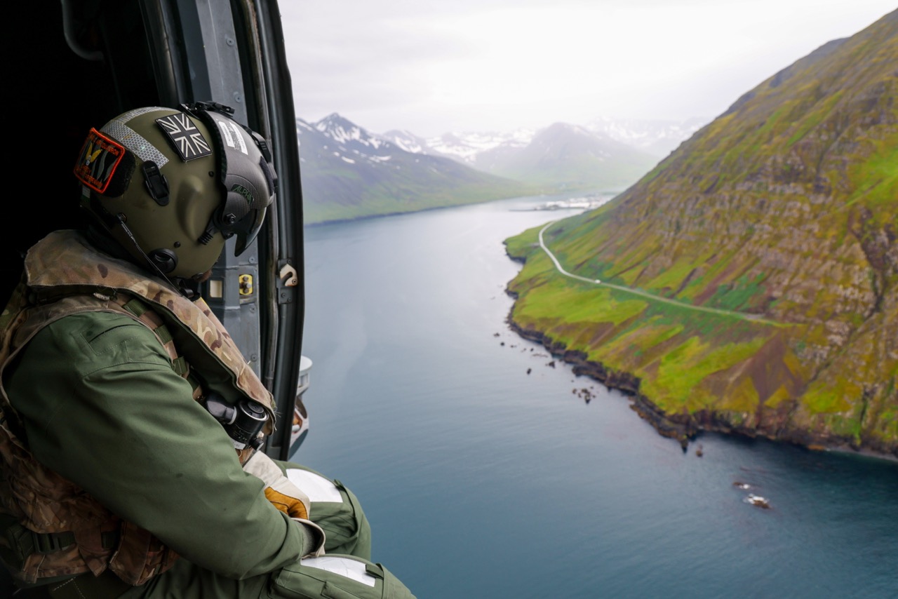 14 Jul 2026 – Aircrewman from 814 Naval Air Squadron sat in the door of a merlin helicopter as it fly’s through the Mountains in Iceland.UK Carrier Strike Group is under the command of NATO as it conducts Air Policing in the vicinity of Iceland, the first time the mission has been conducted from an Aircraft Carrier. The Airborne Surveillance and Interception Capabilities to Meet ISL's Peacetime Preparedness Needs (ASIC-IPPN) is a peacetime mission, which is specific and unique to Iceland. UK CSG in conjunction with the Iceland authorities, is providing a presence of F-35B fifth generation fighter aircraft from 809 NAS embarked on HMS Prince of Wales, to keep Icelandic airspace safe and secure.This mission alongside previous exercises conducted with NATO Allies demonstrate the Strike Group's ability to operate effectively in a complex and strategically significant region while focused on NATO’s drive of preserving peace, security and cooperation in the Arctic. The multi-domain exercises reinforce co